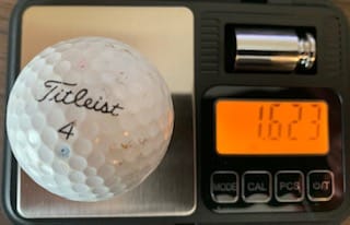 golf ball on scale showing 1.623 ounces
