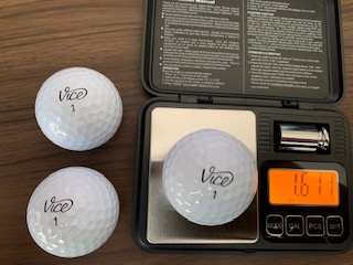 New Vice Golf ball on a scale showing a weight of 1.611 ounces. 