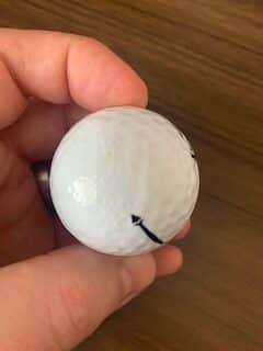 Recycled cheap golf ball with side melted or painted too much.  Dimples are missing.