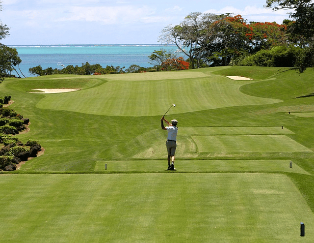 Golfer hitting off the tee.