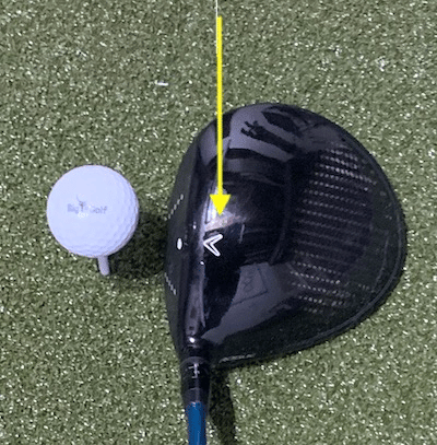 Driver setup to a golf ball, with arrow directing where to look.