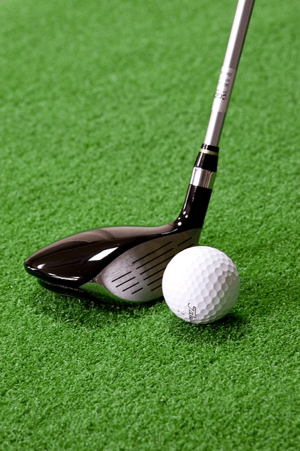 A golfer using a fairway wood on a long fairway shot, demonstrating when to use what golf club for optimal performance.