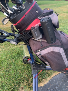 Blue tees golf series 3 rangefinder and speaker mounted on golf bag