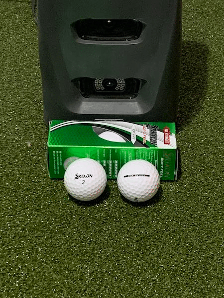 Srixon Soft Feel Golf Ball next to a GC3 launch monitor