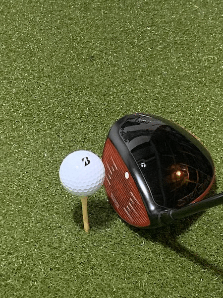 The Bridgestone e6 golf ball on a tee, taking tee shots for the review