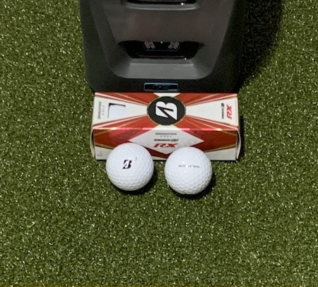 Bridgestone Tour B RX golf balls in front of the GC3 launch monitor.
