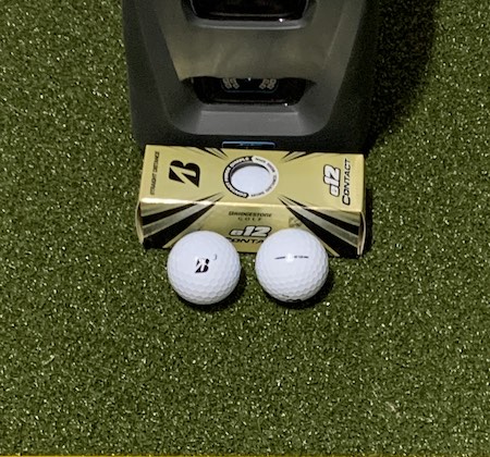 Bridgestone e12 Contact golf balls in front of the GC3 launch monitor.