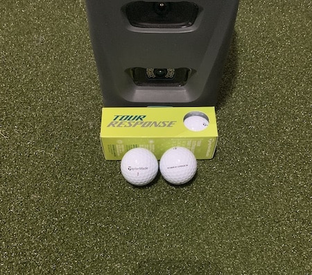 Taylormade Tour Response golf balls in front of a GC3 launch monitor.