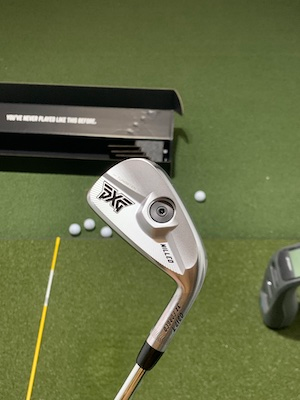 PXG 0317 T Iron with GC3 and golf balls in background.